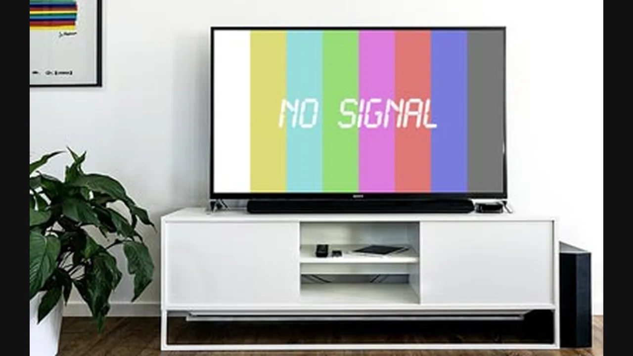 Television on a white stand showing colour bars and the words NO SIGNAL
